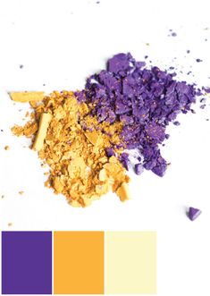 some purple and yellow colors are on the white table with it's color swatches