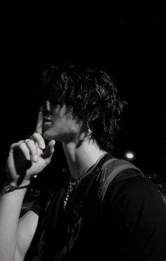 black and white photograph of a man holding his finger up to his mouth