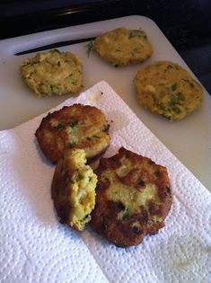 three crab cakes on a towel next to some other food items in the microwave oven