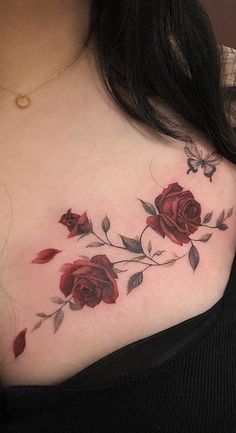 a woman's chest with red roses on it