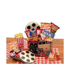 a movie themed gift basket with popcorn, movies and other snacks on a checkered tablecloth