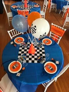 an orange and white checkered table with balloons