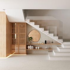 an empty room with white stairs and wooden shelves on the wall, next to a potted plant