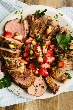 a white plate topped with meat and fruit