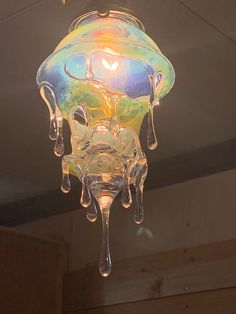 a multicolored glass chandelier hanging from the ceiling