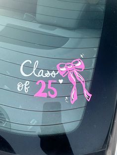 the back window of a car with a pink bow and number 25 sticker on it