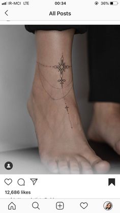 a person's foot with a small tattoo on the ankle and an arrow in the middle