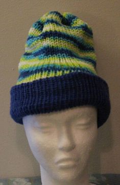 This is a knitted reversible winter hat.  Made of 100% acrylic yarn.  Machine wash and dry. Blue Knit Beanie Hat, Blue Knit Beanie, Casual Brimmed Acrylic Beanie, Blue Acrylic Yarn Winter Hat, Knitted Acrylic Yarn Hat For Outdoor Use, Outdoor Knitted Hat In Acrylic Yarn, Outdoor Knitted Hat Made Of Acrylic Yarn, One Size Brimmed Acrylic Beanie, Casual Blue Yarn Beanie