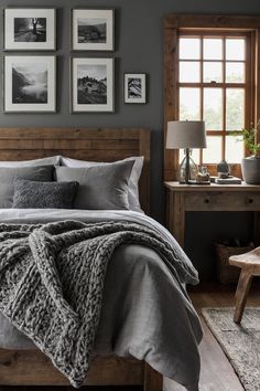 a bedroom with gray walls and pictures on the wall