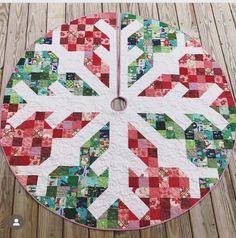 a clock made out of quilts on top of a wooden floor with the time in between