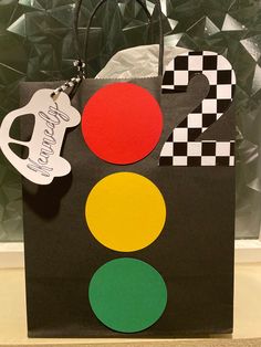 a black shopping bag with a happy birthday sign on it and a traffic light decoration