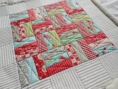 a close up of a quilt on a bed