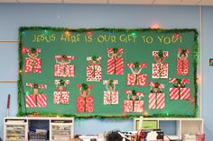 a bulletin board decorated with christmas stockings and reindeers in front of a green background