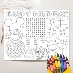 a birthday coloring page with crayons and markers on the table next to it