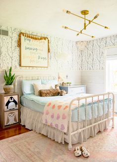 a bed room with a neatly made bed and a painting on the wall above it