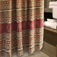 a bathroom with a shower curtain and towels