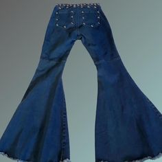 Custom Roncelli / 70s Style Dome Studded Super Flare  Bell Bottom Jeans *Size Small *High Waisted  *Stretchy Slimming Dark Blue Denim *Steel/ Chrome Dome Large Studs  *Super Wide Flare / Bell Bottom With Reinforced Frayed Hem *Excellent condition Approximate Flat Measurements: Waist 13" (up to 15" max when stretched)  Doubled = 26" (up to 30" max when stretched) Flare 17.5"  Crotch to bottom 29" Total length 40" "just in case" spare studs included with order (in the very rare case your festival partying causes you to lose one somehow, or perhaps get creative and adorn something else you own with the spares such as a matching choker or attach to a top you wear with the pants ) 90s High Waist Blue Flare Jeans, 90s Style Blue Mid-rise Flare Jeans, 90s High Waist Denim Blue Flare Jeans, 90s Style High Waist Denim Blue Flare Jeans, High Rise Grunge Flare Jeans In Denim Blue, Retro Stretch High Rise Flare Jeans, 90s High Rise Flare Jeans In Denim Blue, Retro High Rise Stretch Flare Jeans, 90s Style Summer Denim Flare Jeans