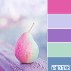 a pear sitting on top of a wooden table next to a color swat list with different shades