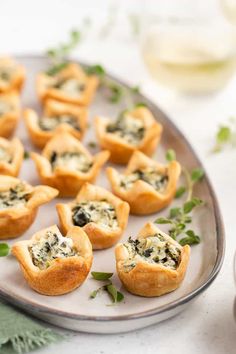 small appetizers with cheese and herbs on a plate