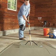 a man is using a floor leveler on concrete