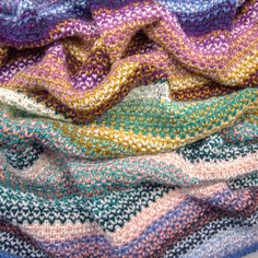 multicolored knitted blanket folded on top of each other