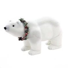 a white polar bear with a wreath around its neck