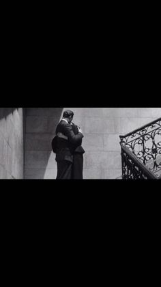 a man standing next to a stair case