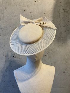 Very fine Balibuntal shaped on a button block with a wired Sinamay brim. There is a hat elastic attached that will keep this fascinator safely on your head and is meant to be worn on the back of the head underneath the hair.  If need be, we can attach the little cocktail hat onto an Alice band or sew combs in there if you wish.It comes with a lovely hatpin that attaches the bow to the hat. It is shaped by hand in our lovely workshop in the historical courtyards in Hackesche Höfe, in the centre of Berlin, Germany.  Everything on this hat is sewn with many, many visible stitches and by hand.  This is truly a wonderful piece of millinery workmanship and the result of a passion for beauty and perfection. This a unique piece and a one off.  If we should attempt to make it in another colour, ple Trilby Fedora, Occasion Hats, Back Of The Head, Wedding Fascinators, Cocktail Hat, Alice Band, Pill Boxes, Satin Wedding, Beautiful Hats