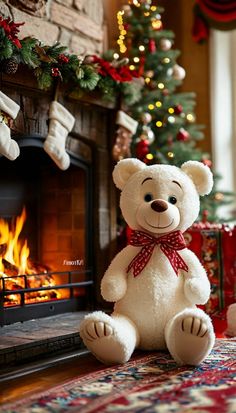 a white teddy bear sitting in front of a fire place with stockings on the mantel