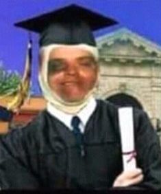 a man wearing a graduation cap and gown holding a diploma in front of a building