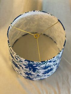 a blue and white lamp shade sitting on top of a table