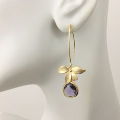 "Purple Amethyst Earrings, Gold Flower Earrings, Orchid Floral Earrings, Flower Dangles, Dangle Drop Earrings, February Birthstone Gift, Wedding Bridal Earrings, Bridesmaid Gift Idea Gold Orchid Amethyst Dangle Earrings These darling earrings consist of a matte gold plated orchid flower connector with a bezel set faceted purple glass teardrop dangling from long gold tone copper ear wires. Available in short and long dangle: Short dangle is 1.25\" from top of ear wire. Long dangle is 2\" from top Amethyst Earrings Gold, Purple Amethyst Earrings, Gold Flower Earrings, Bridesmaid Necklace Gift, Gold Orchid, Hippie Earrings, Earrings Bridesmaid, Birthstone Gifts, Bridesmaid Necklace