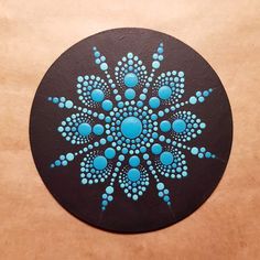 a black and blue circular design painted on wood