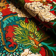 close up view of colorful fabric with flowers and birds on it's surface,