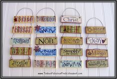 wooden signs are hanging on the wall in different colors and sizes, with words above them