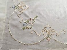 an embroidered piece of cloth with flowers on it