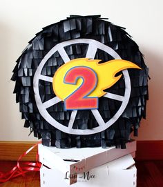 a birthday cake made to look like a wheel with the number two on it