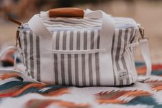 Whether you're heading out for a day at the beach, a picnic in the park or a BBQ in your backyard, enjoying an ice-cold beverage on a hot day is an absolute must. Our premium insulated cooler and food warmer bags are here to perfect your ultimate all-day Summer set up, keeping your food and drinks cold and crisp, from sunrise to sunset. This bag can be used for takeout food, potluck food carrier, casserole dish carrier, family style picnic basket bag, hiking food storage bag and many more!  This Rectangular Lunch Bag For Summer Outdoor, Practical Travel Tote Lunch Bag, Practical Tote Lunch Bag For Travel, Rectangular Summer Outdoor Lunch Bag, White Reusable Travel Bags, White Outdoor Tote Bag, White Tote Bag For Outdoor, Rectangular White Lunch Bag For Travel, White Large Capacity Bag For Picnic