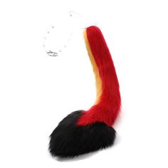 a red and black furry tail on a white background