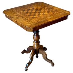 an old wooden table with a checkered design on it's top and legs