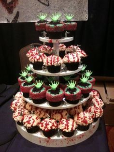 cupcakes are stacked on top of each other with green and red frosting