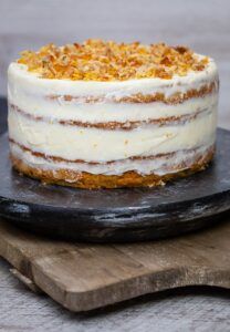 a cake sitting on top of a wooden cutting board