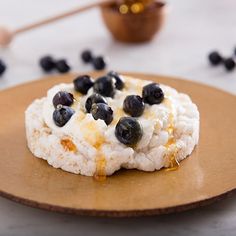 a desert with blueberries and cream sits on a plate