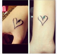 two small tattoos on the wrist, one with a heart and another with a leaf