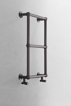 an old fashioned towel rack hanging on the wall in a room with white walls and flooring