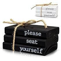 three black books tied with twine and the words please seat yourself are placed next to each other