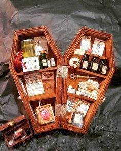 an open wooden box with various items inside