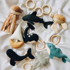 an assortment of stuffed animals laying on top of a white sheet with rings around them