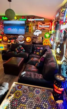 a living room filled with lots of furniture and neon signs on the wall above it