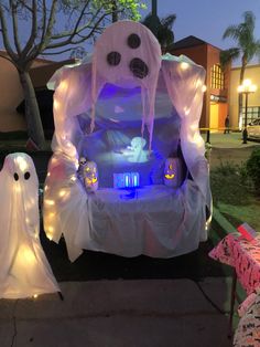 an inflatable ghost car is decorated with lights and decorations